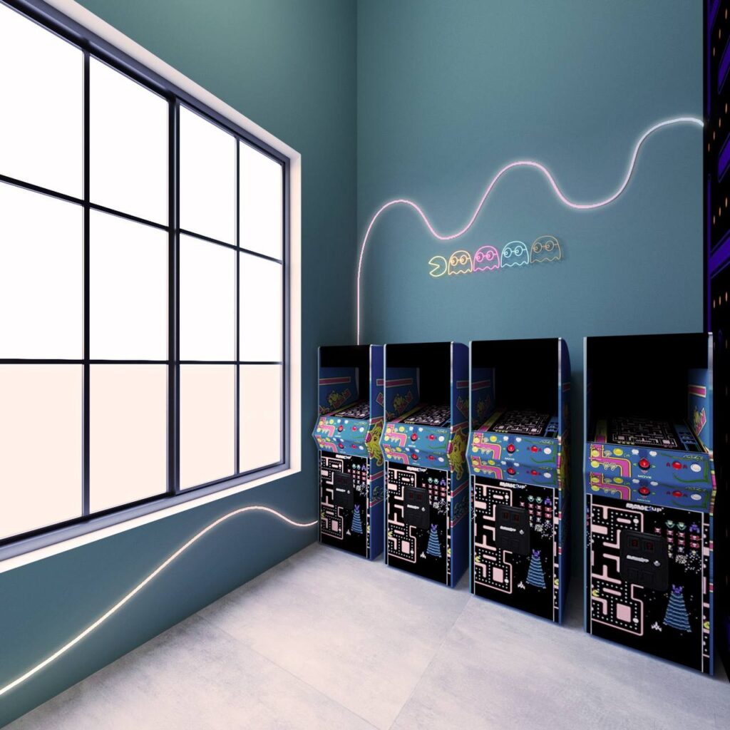 pediatric dental center game room with arcade machines and neon wall graphics
